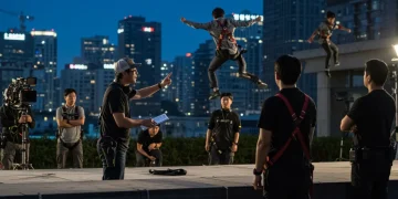 U.S.-based K-drama stunt coordinator overseeing an intricate action scene with actors and crew.